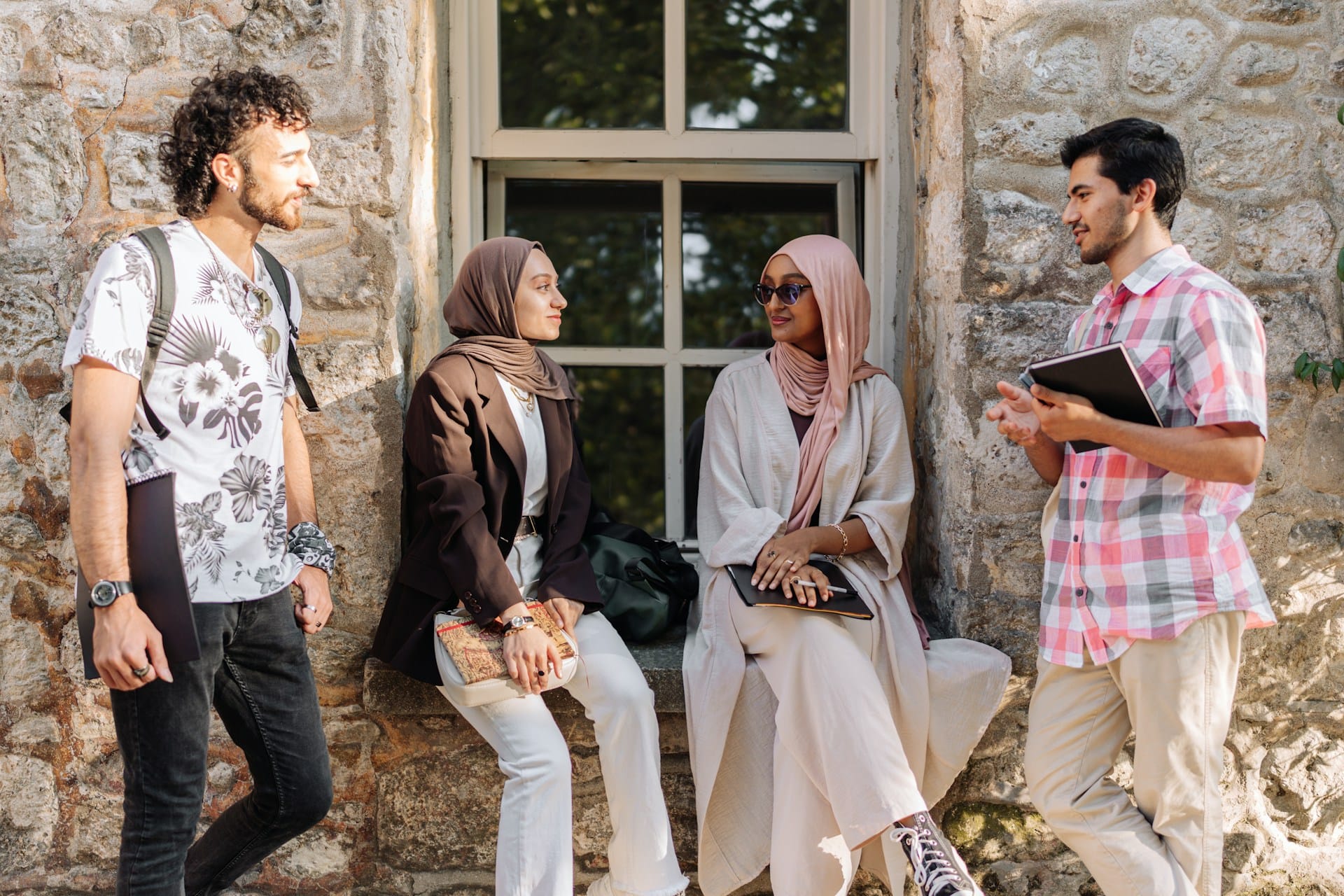 Group of international university students talking outside a stone building in Turkey.