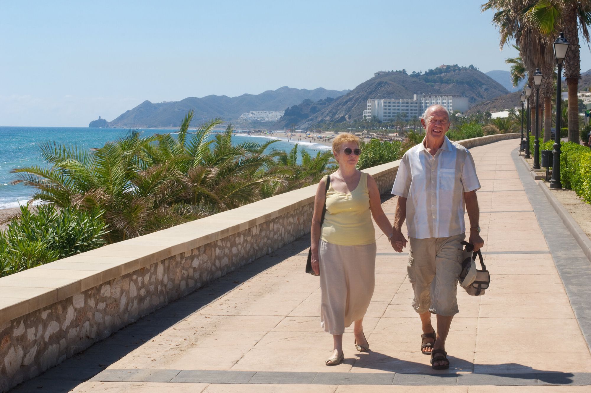 Senior Couple Walking on Holiday or Are They Expatriates — Getty Images