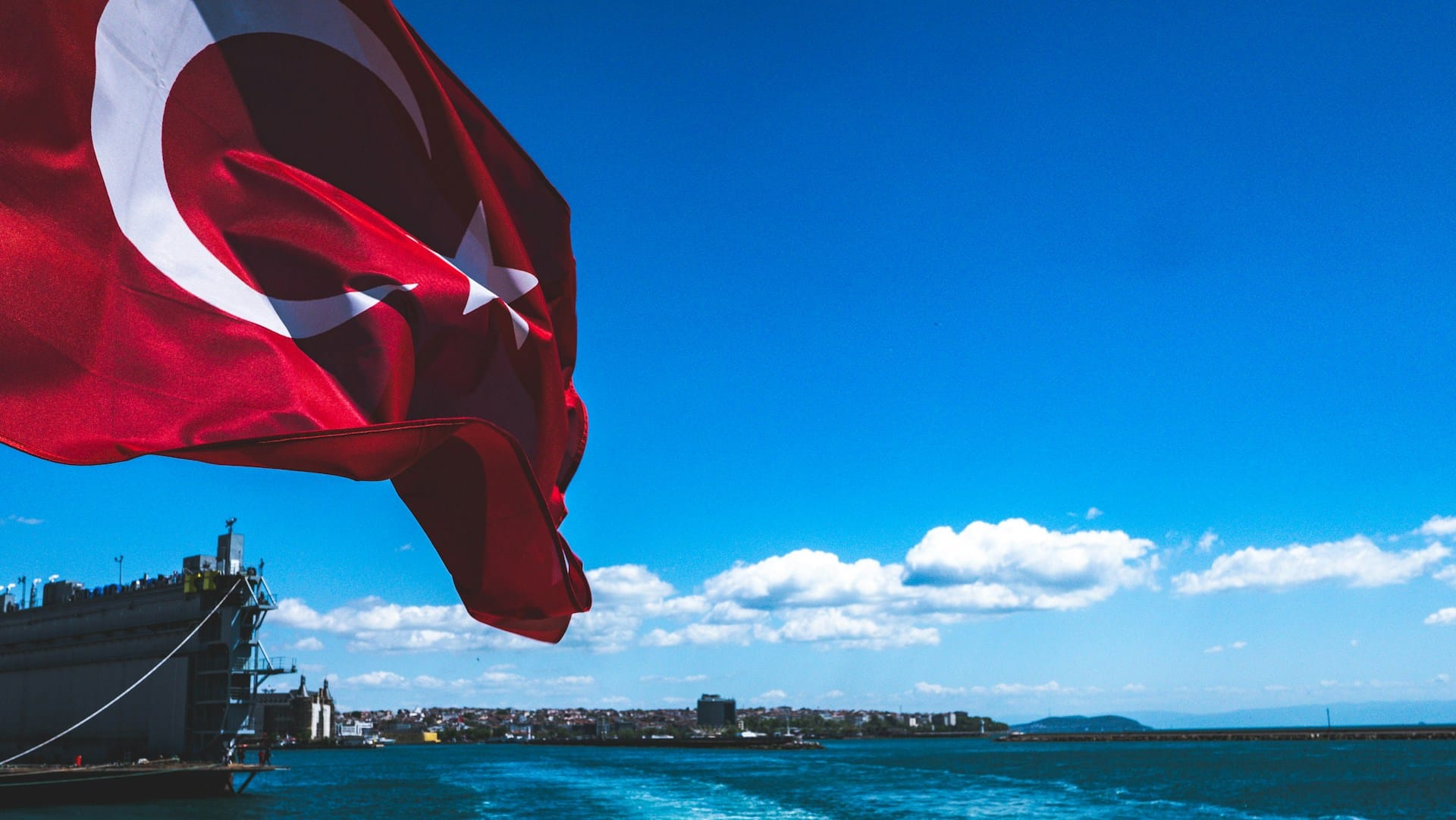 Turkish flag blowing in the wind leaving Istanbul harbor