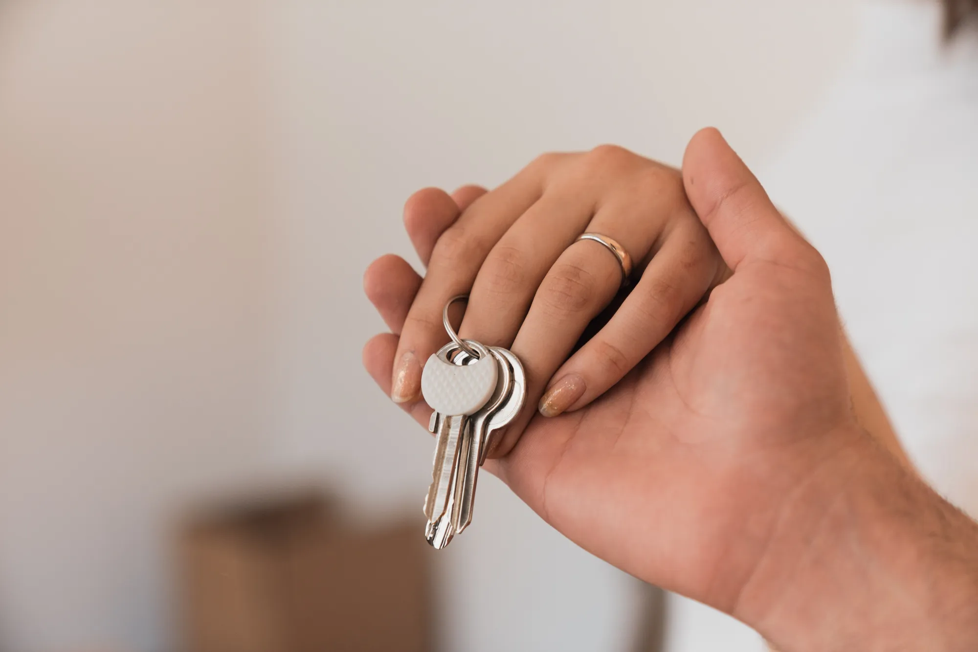 hands holding house keys