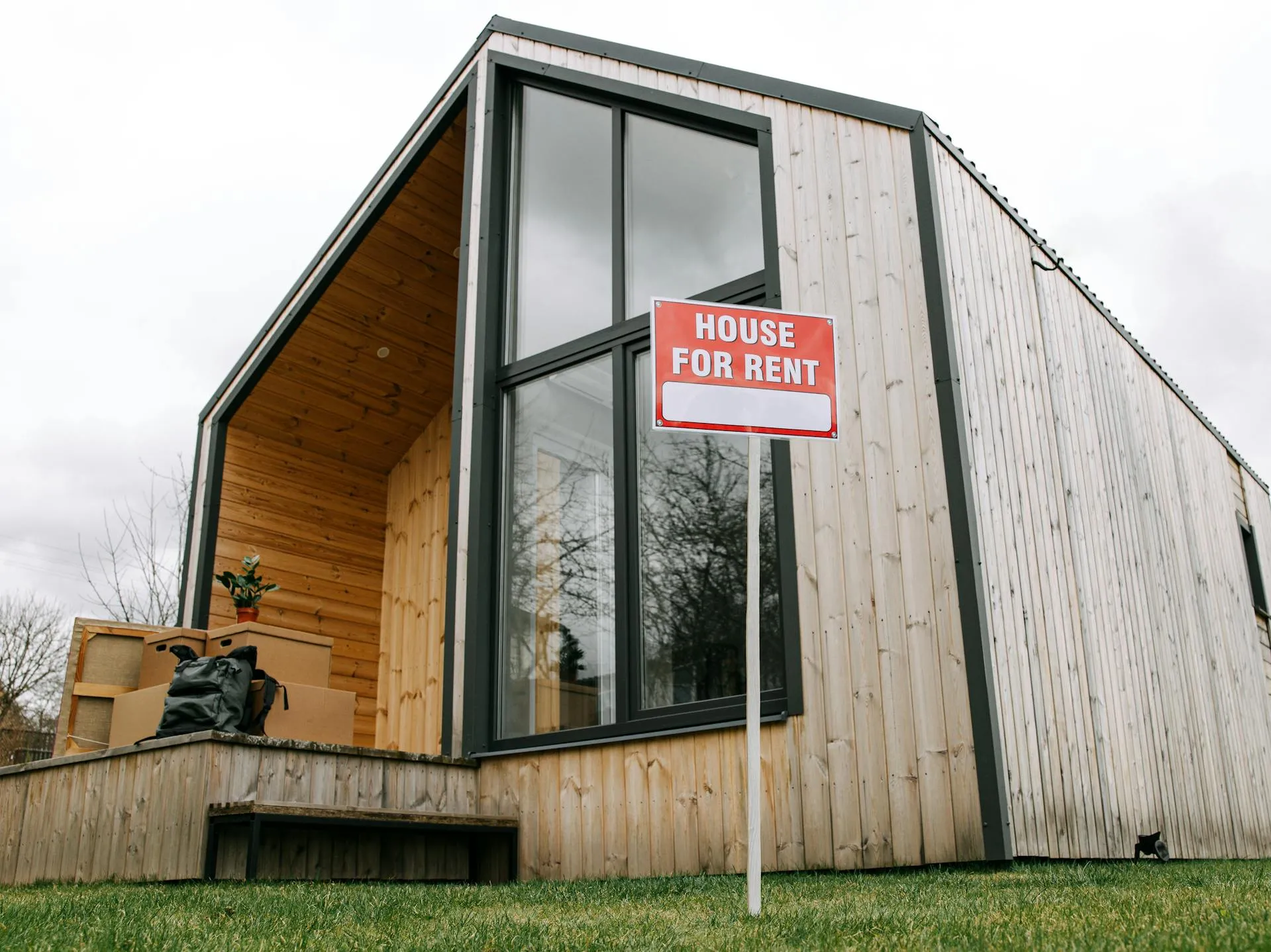 Turkish rental home with 'House for Rent' sign, boxes, plant, yard—perfect for expats via Ikamet